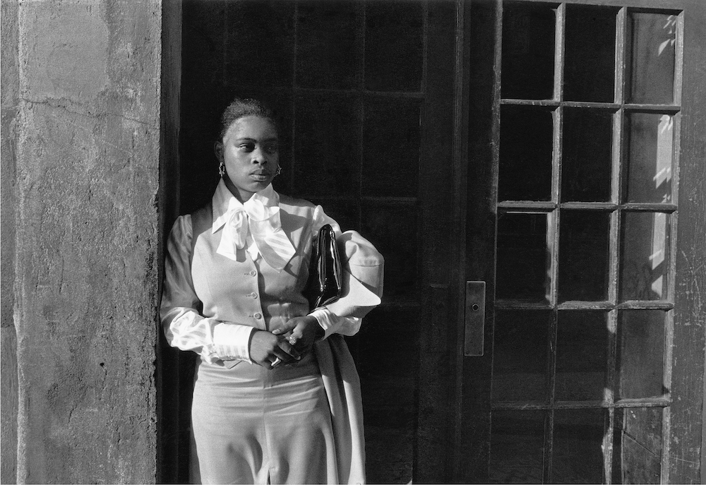 Dawoud Bey, “A Woman Waiting in the Doorway, Harlem, NY,” from the series Harlem, U.S.A., 1976; courtesy the artist and Sean Kelly Gallery, Stephen Daiter Gallery, and Rena Bransten Gallery; © Dawoud Bey 